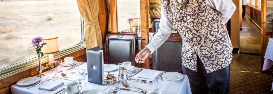 Waiter attending dinner table on the Blue Train